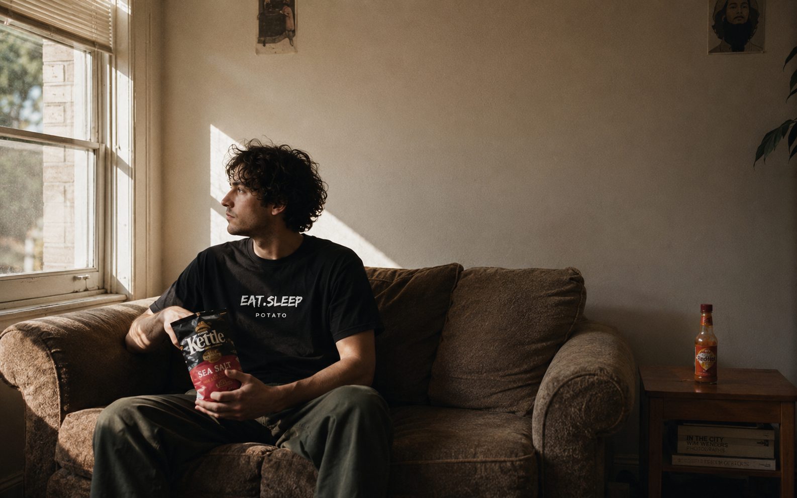 A pledged spud in an Eat Sleep Potato tee, weekday afternoon, chips in hand, deadpan.